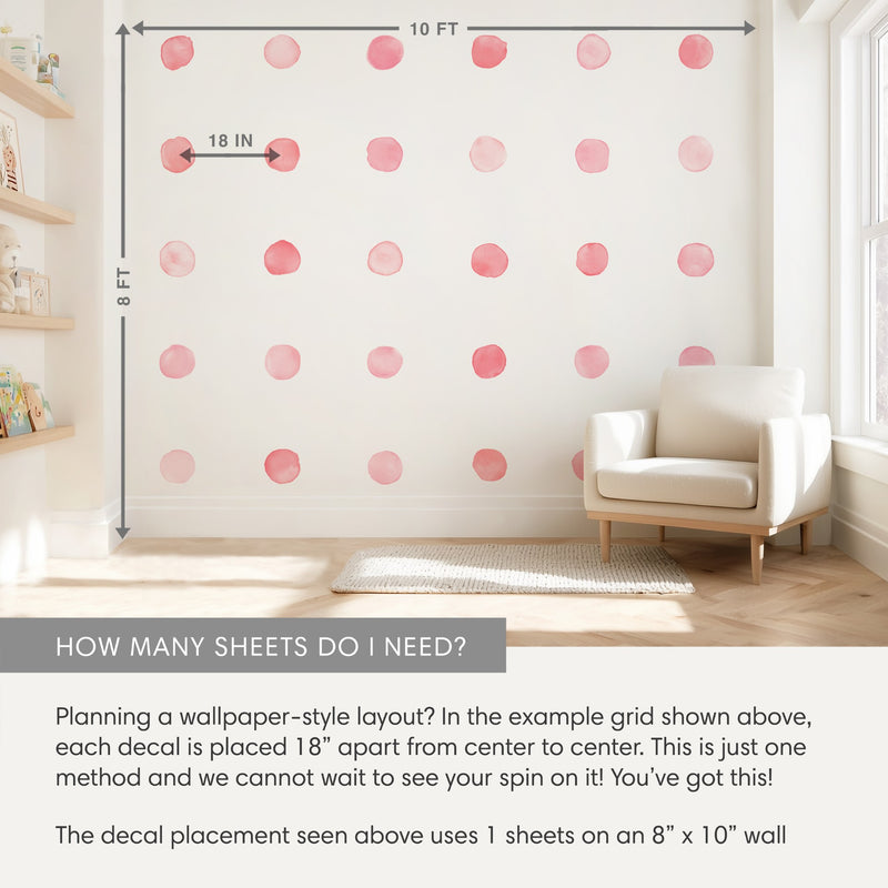 Pink watercolor polka dot peel-and-stick decals in a 5x4 grid on an 8x10 ft nursery accent wall, 18 in spacing, with white armchair and shelves