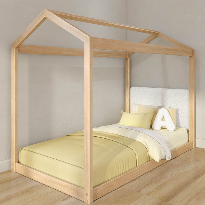 Natural light wood house-shaped canopy kids bed with yellow bedding, plush letter A pillow on toddler floor bed in modern nursery