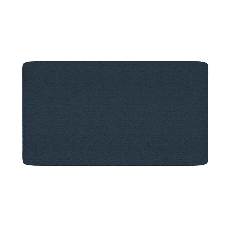 Navy blue rectangular bath mat with rounded corners and textured surface on white background