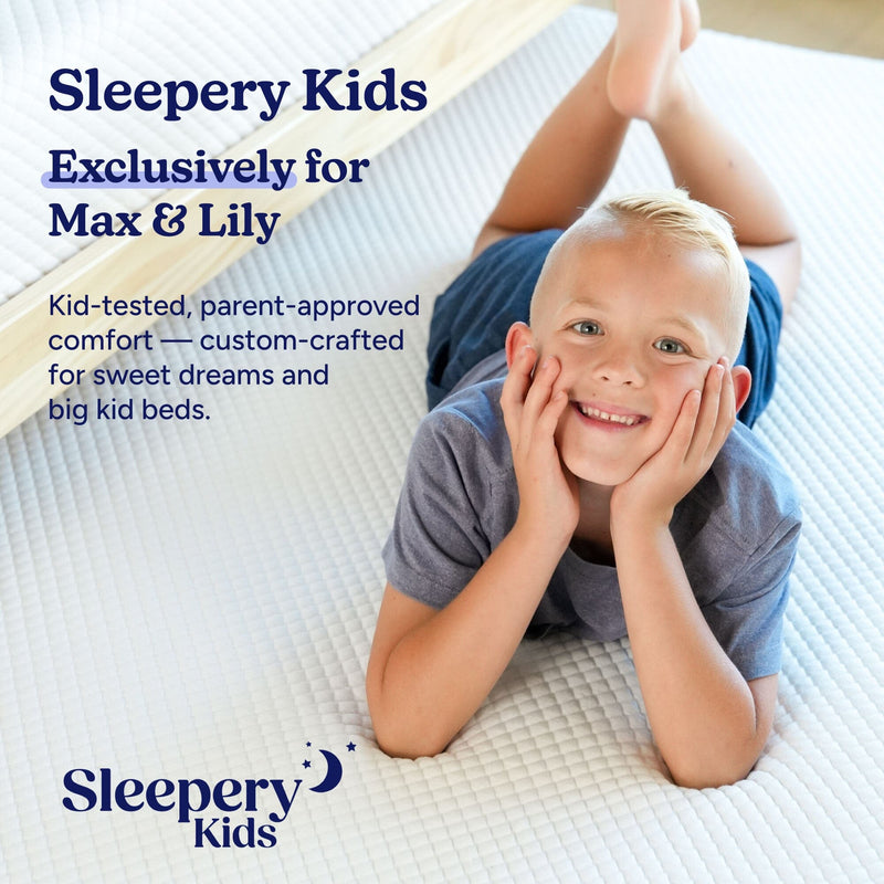 Smiling child lying on a white quilted Sleepery Kids mattress — kid-tested, parent-approved comfortable children's mattress for sweet dreams