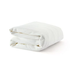 Folded white blanket on a white background.