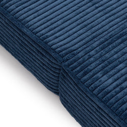 Close-up of a navy blue ribbed corduroy cushion showing plush textured fabric for sofa throw pillow and home decor