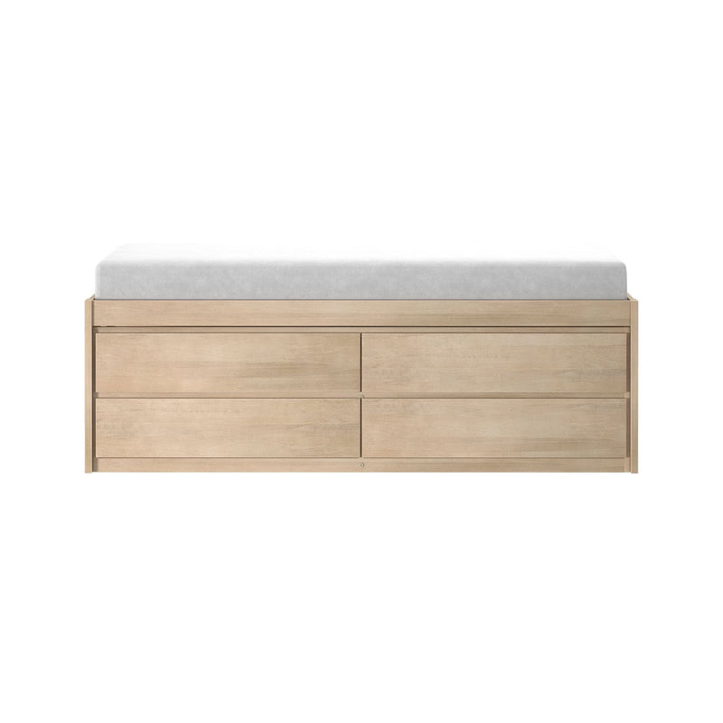 Minimalist light oak six-drawer dresser topped with a gray mattress pad on a white background
