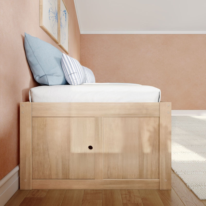 Cozy minimalist bedroom corner with light wood bed frame, blue striped pillows and framed butterfly art on a blush textured wall