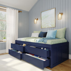 Small bedroom with blue panel walls featuring a multi-functional navy daybed with drawers, green checkered pillows, and wall sconces, perfect for a cozy and organized space.