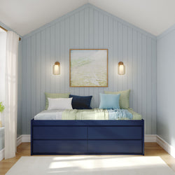 Cozy minimalist bedroom with blue walls, navy storage bed, and modern wall art.