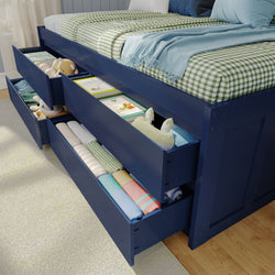 Children's bedroom storage bed with pull-out drawers holding toys, books, and neatly folded clothes.