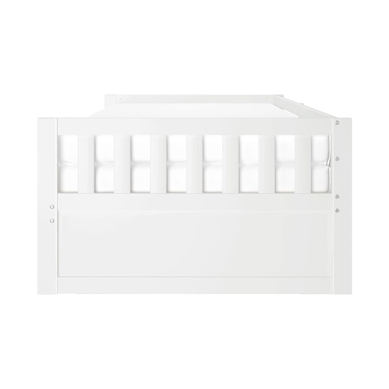 Close-up front view of modern white wooden baby crib with vertical slats and mattress for nursery
