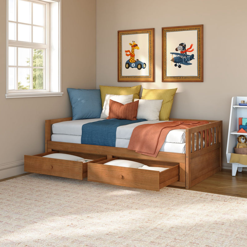 Kids bedroom with wooden trundle bed and open under-bed storage drawers, colorful pillows, animal wall art and natural window light