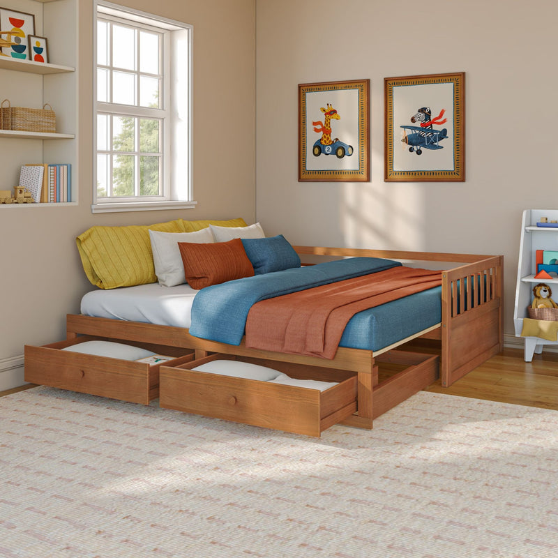 Children's bedroom with wooden trundle bed and under-bed storage drawers, teal and rust bedding, framed giraffe and zebra wall art, toy shelf and bright natural window light