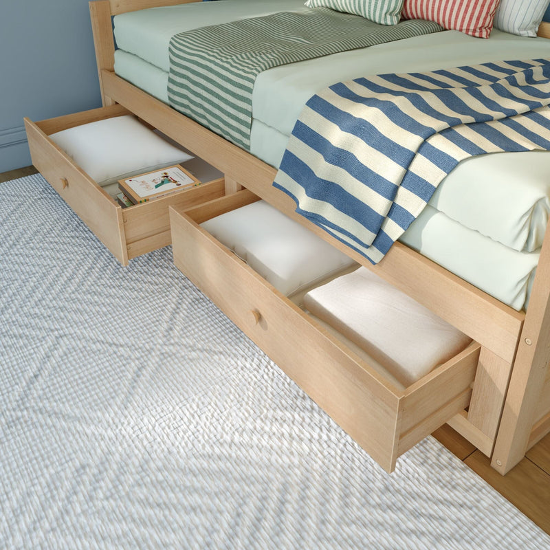 Light wood bed with built-in underbed storage drawers open, pastel mint bedding and blue-and-white striped throw blanket — space-saving bedroom storage and organization solution