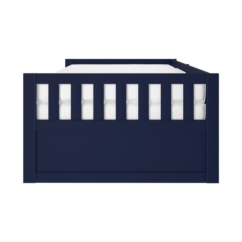 Front view of navy blue wooden toddler bed frame with white mattress and vertical slatted guardrail, modern nursery furniture