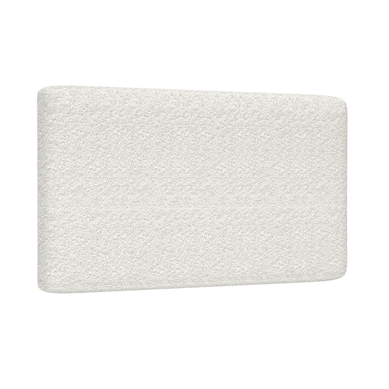 Close-up of white bouclé upholstered headboard showing textured fabric and rounded corner, modern minimalist bedroom furniture