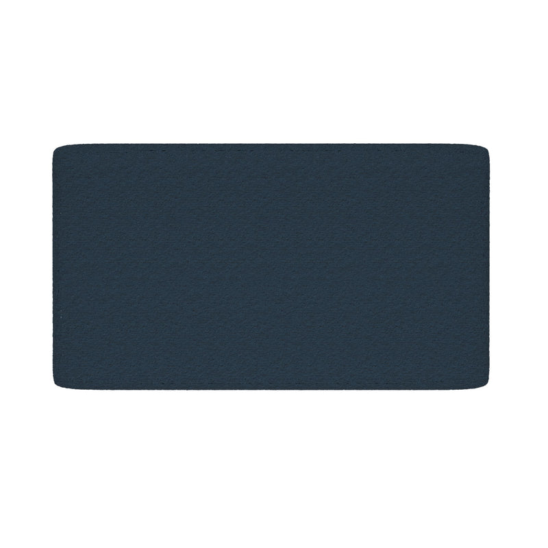 Close-up of navy blue textured bath mat with rounded corners on a white background