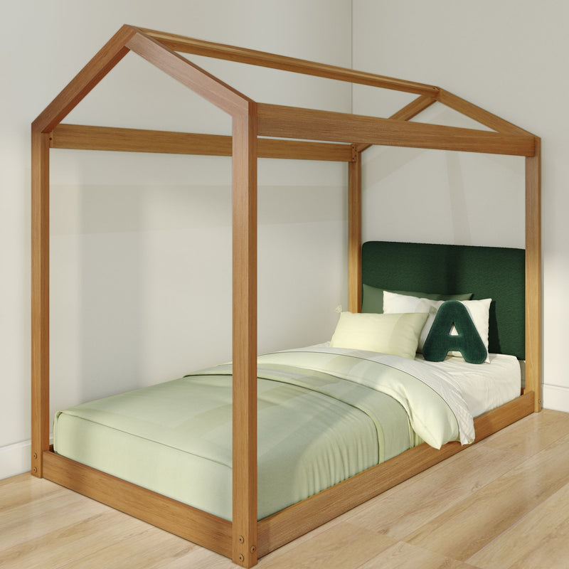 Wooden house-shaped twin bed frame with green upholstered headboard, pastel green bedding and natural wood flooring in a modern minimalist children's bedroom