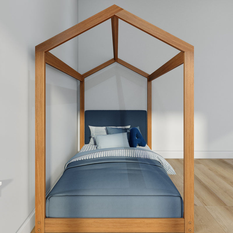 Wooden house-frame canopy kids bed with navy blue bedding and striped pillows in a minimalist children's bedroom with light oak floors