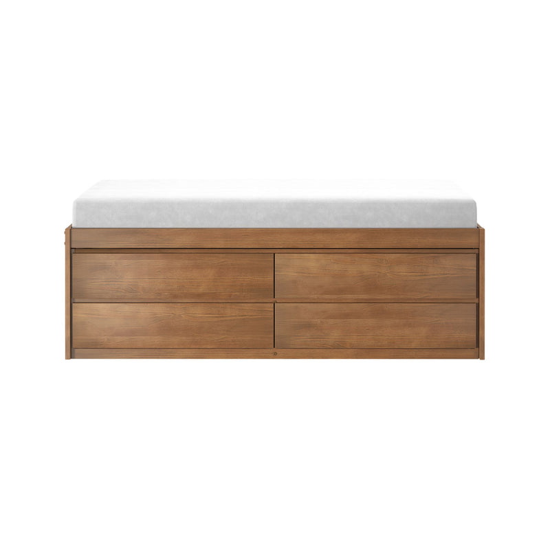 Modern natural wood dresser with drawers topped by a white mattress pad, isolated on a white background