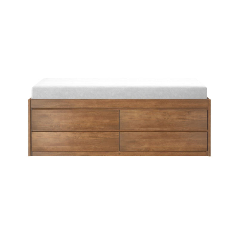 Modern natural wood dresser with drawers topped by a white mattress pad, isolated on a white background
