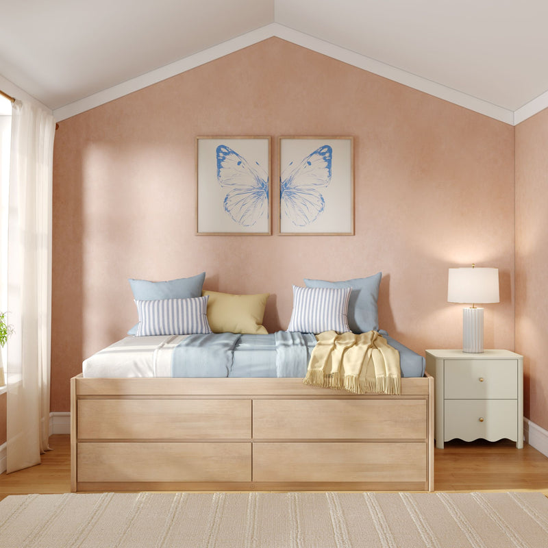 Cozy pastel bedroom with pink textured accent wall, wooden platform bed with storage drawers, blue and yellow bedding, striped pillows and butterfly wall art