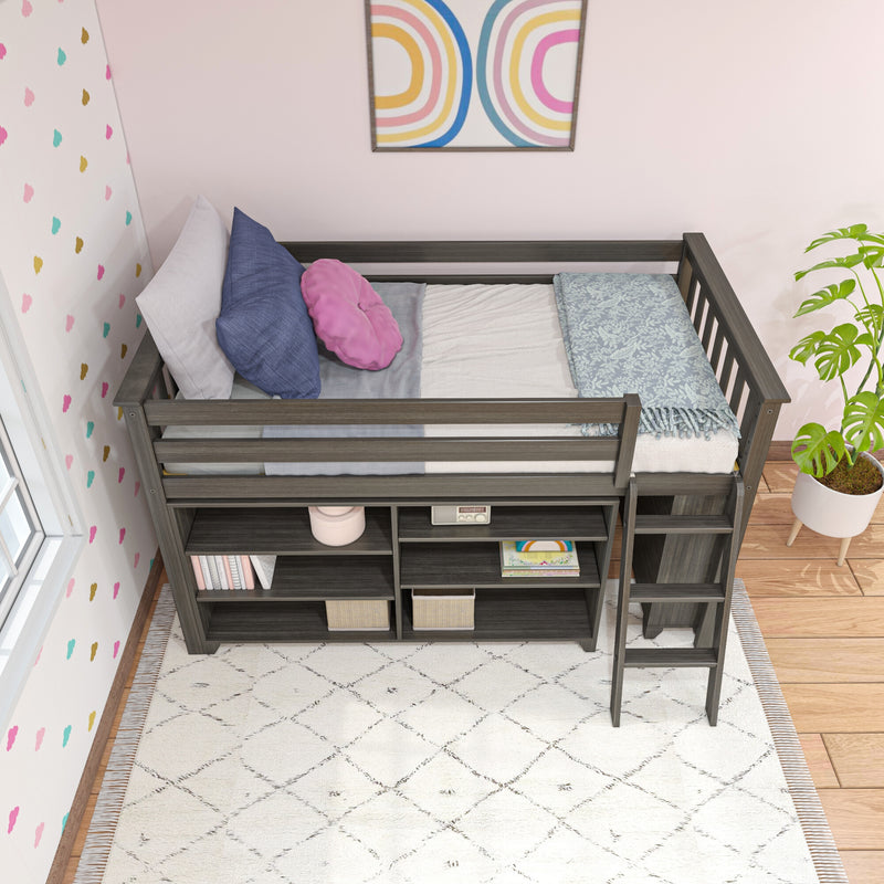 Gray wooden loft bed with built-in storage shelves, pastel pillows and floral throw in a pink kids' bedroom with patterned area rug and potted plant