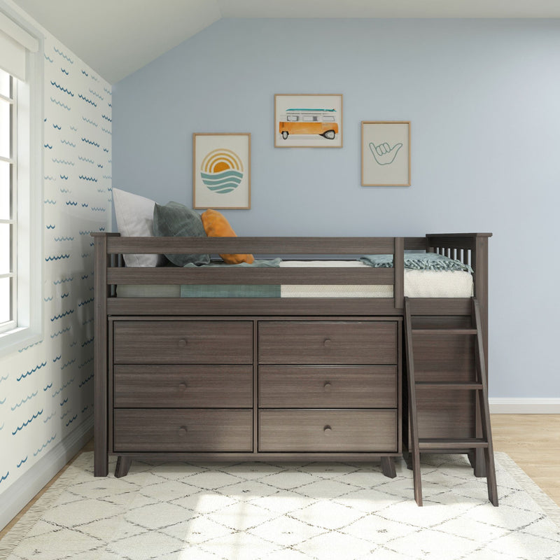 Dark wood loft bed with built-in dresser drawers and ladder in a coastal-themed kids bedroom with blue walls, pillows and beach artwork