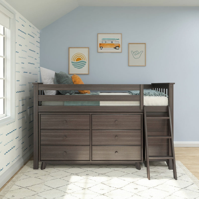 Dark wood loft bed with built-in dresser drawers and ladder in a coastal-themed kids bedroom with blue walls, pillows and beach artwork
