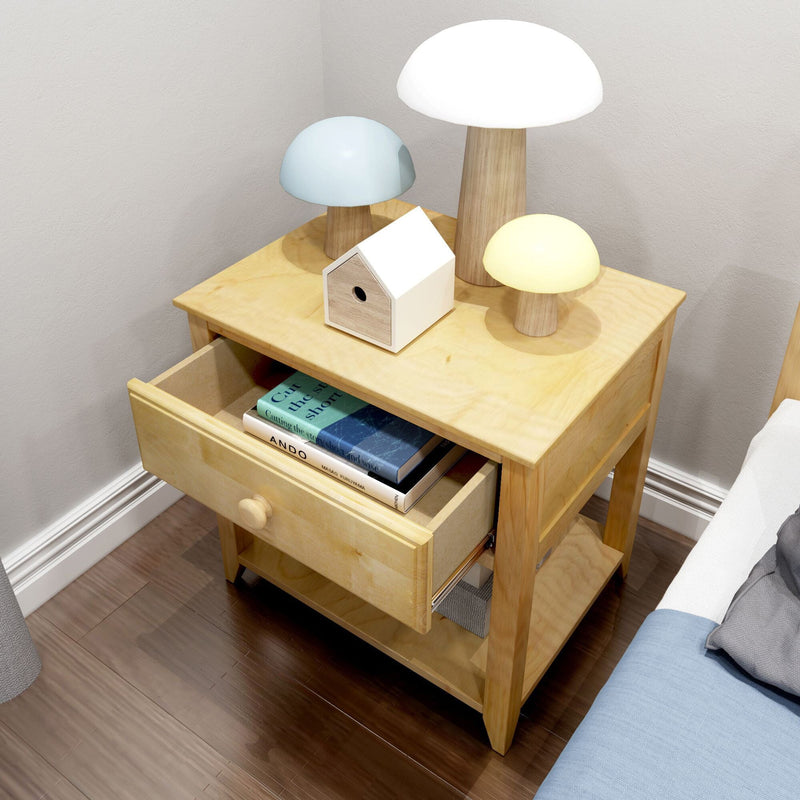 Light wood bedside table with open drawer containing stacked books, three mushroom-shaped lamps (white, blue, yellow) and a small wooden birdhouse on dark hardwood floor, modern minimalist bedroom decor