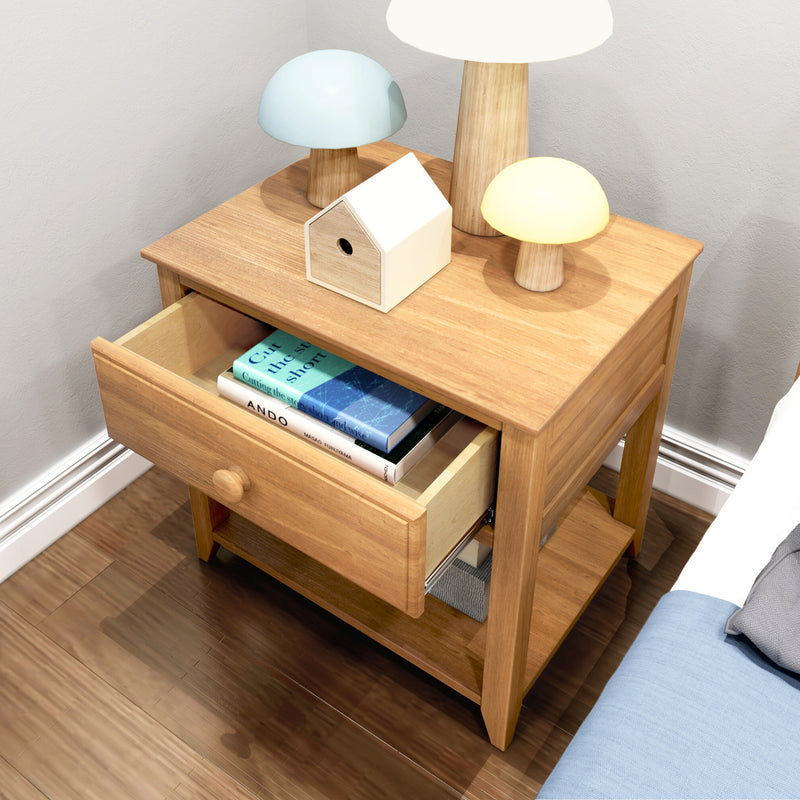 Oak nightstand bedside table with open drawer of books, mushroom-shaped bedside lamps and wooden birdhouse decor in bedroom