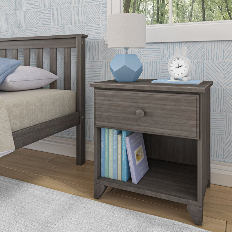 Gray wooden nightstand with drawer and open shelf, featuring blue lamp and white clock, next to a bed in a modern bedroom setting.