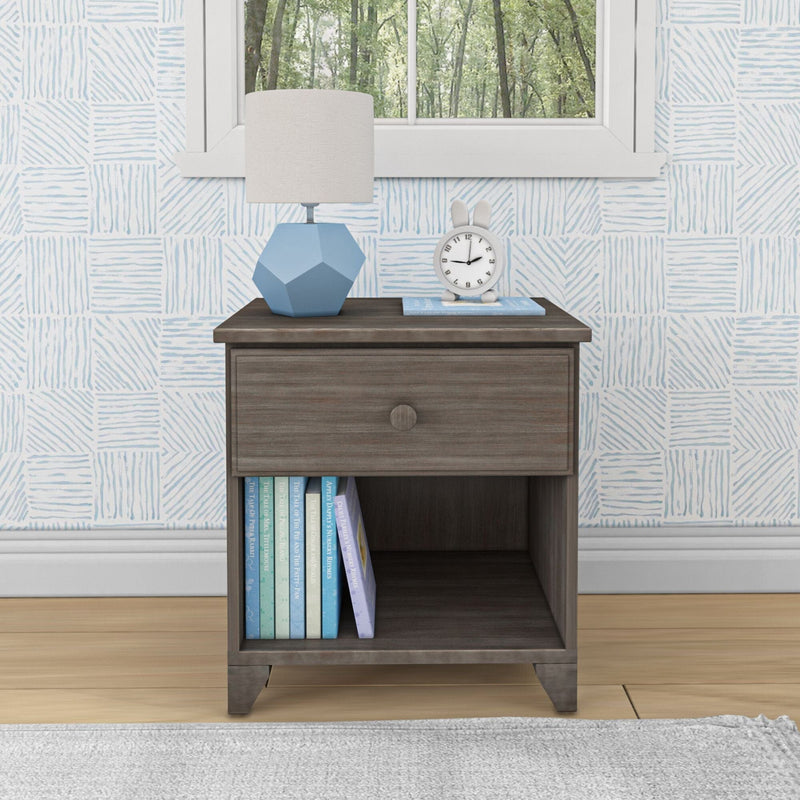 Modern wooden nightstand with books and a lamp in a cozy bedroom setting.
