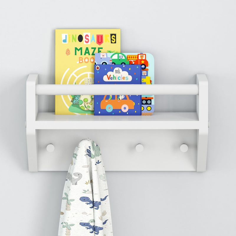 Kids' wall shelf with children's books and dinosaur-print blanket.