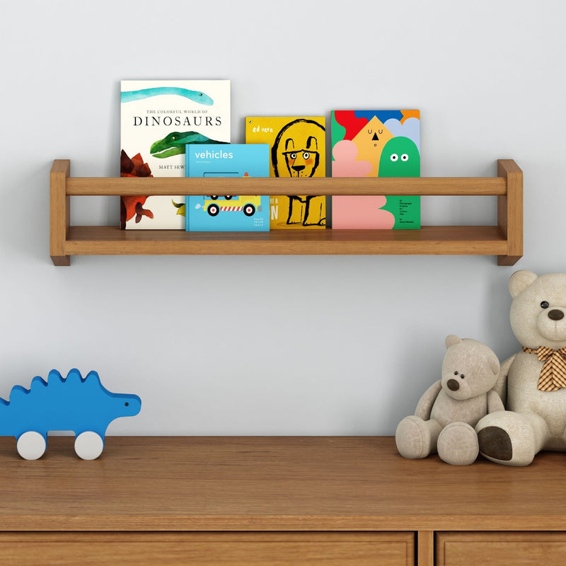 Children's room with wooden shelf displaying colorful books and stuffed teddy bears on a dresser.