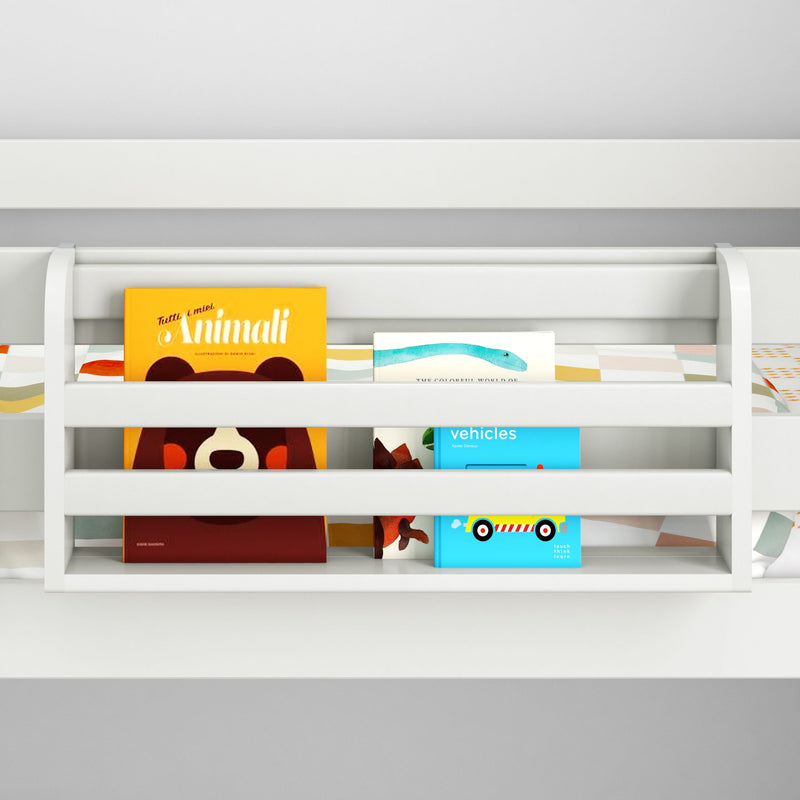 White wooden toddler bed rail with built-in bookshelf holding colorful children's picture books (animals and vehicles) — nursery safety guard