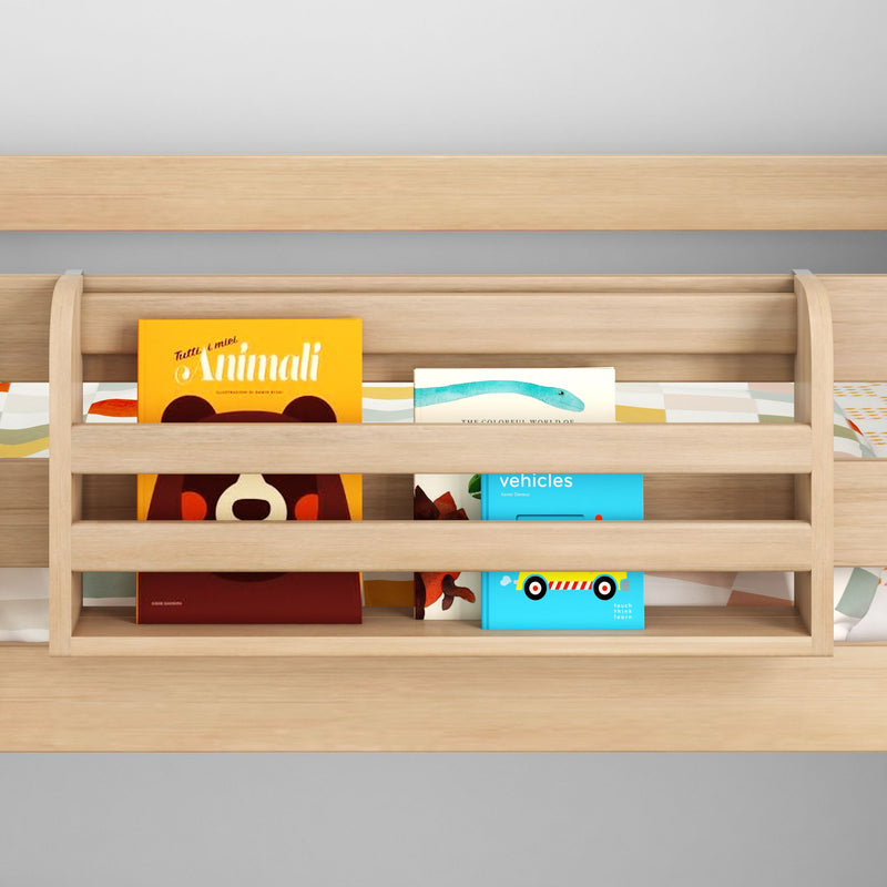 Light wood toddler bunk bed safety rail with built-in book pocket holding colorful children's books and vehicle board book