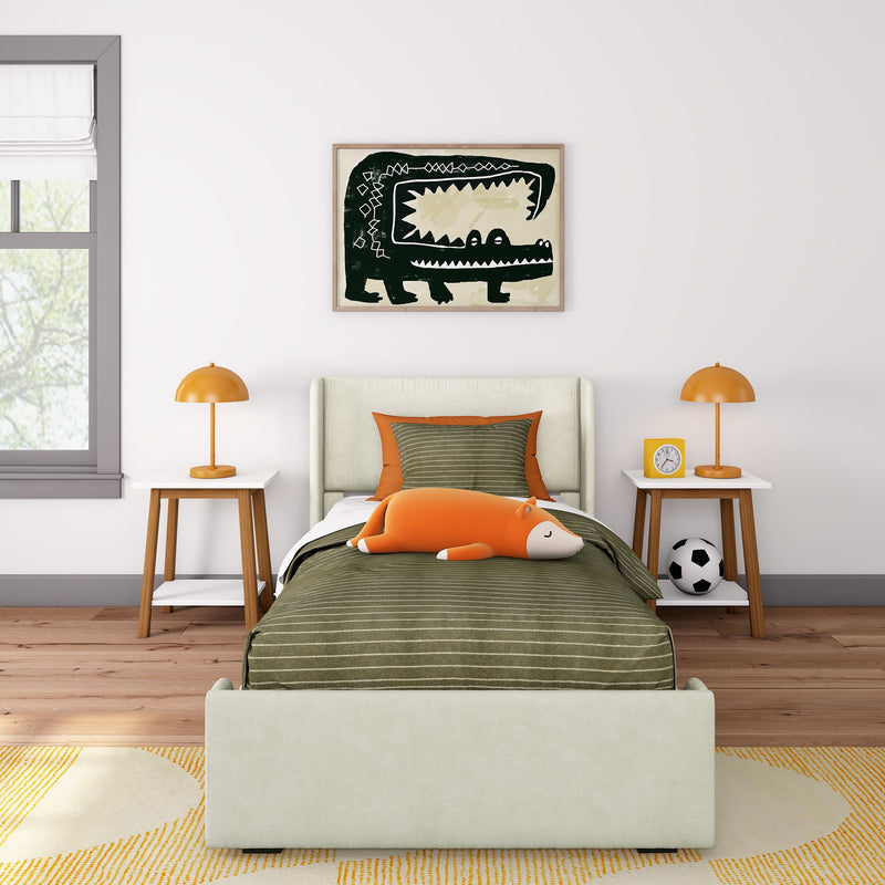 Modern kids bedroom with green striped bedding, framed crocodile wall art, orange fox plush toy, matching orange bedside lamps and a soccer ball