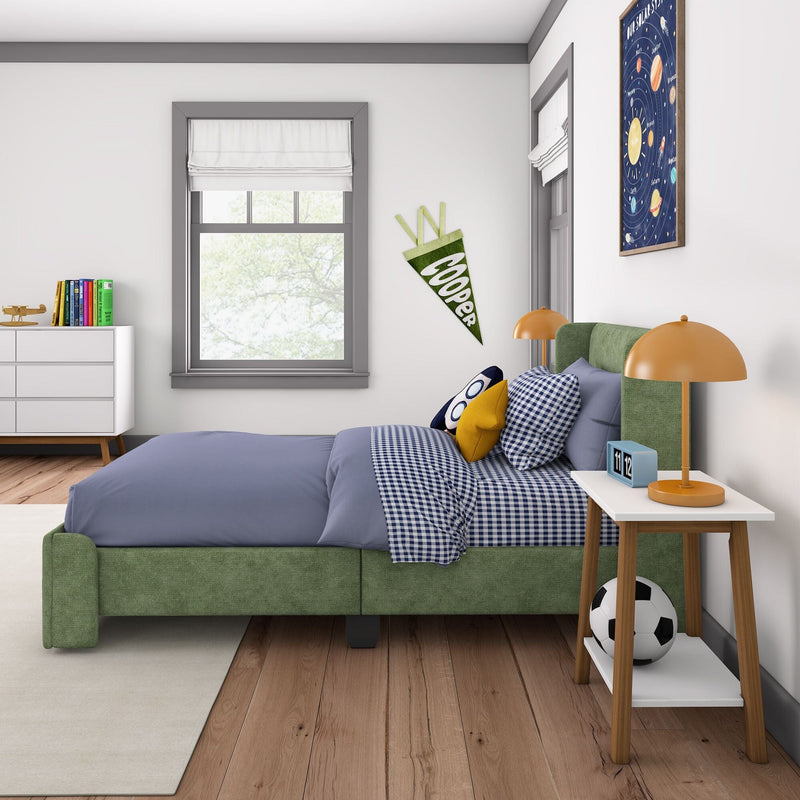 Modern kids' bedroom with green bed, blue bedding, orange lamp, and soccer-themed decor.
