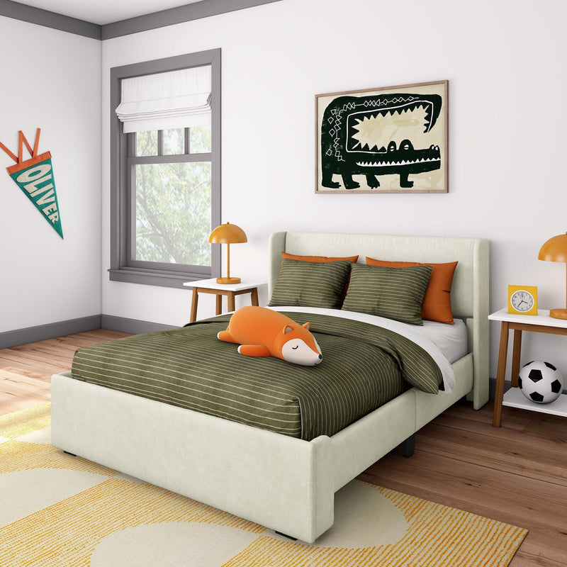 Modern kids bedroom decor with green striped bedding, orange fox plush toy, orange lamps, framed crocodile wall art and "Oliver" pennant
