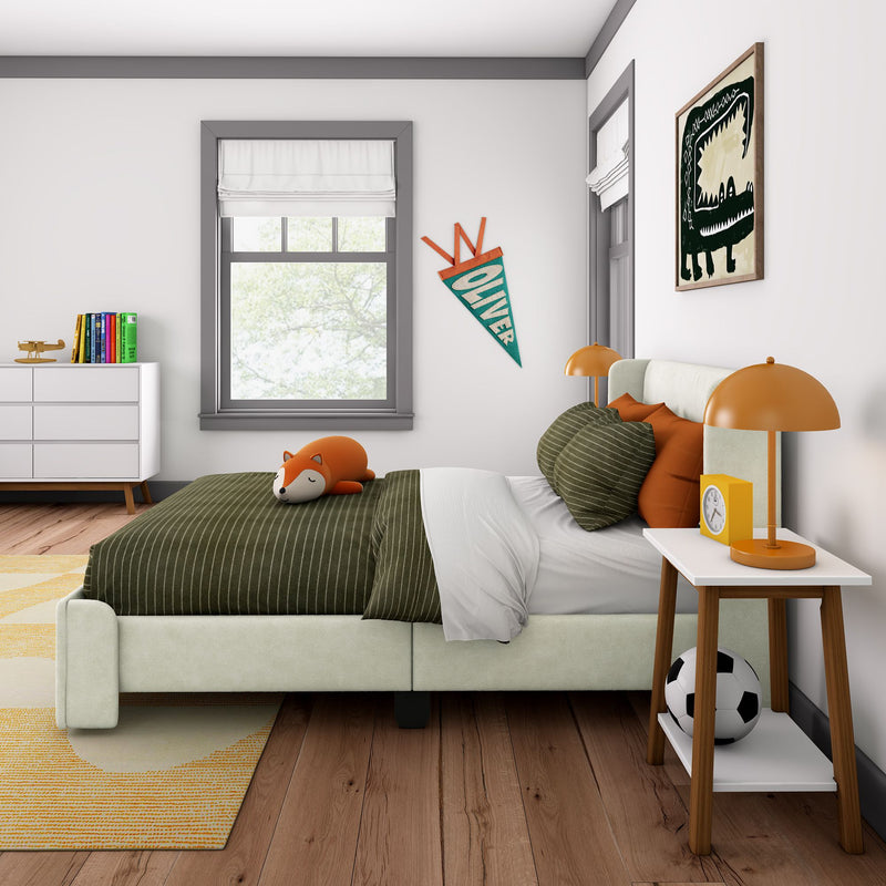 Modern children's bedroom with decorative wall art, comfortable bed with plush fox toy, orange lamp, and wooden nightstand.