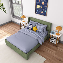Modern kids' bedroom with space-themed decor, featuring a green bed, blue bedding, and playful star and rocket pillows.