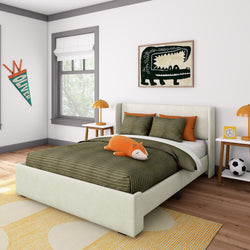 Children's bedroom with green-themed decor, featuring a cozy bed, orange pillows, fox plushie, window, and playful artwork on the walls.