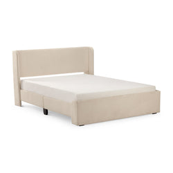 Luxurious beige upholstered bed frame with mattress in modern bedroom setup.