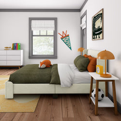 Cozy children's bedroom with green striped bedding, orange accents, and playful decor.