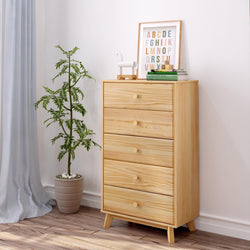 Tall wooden dresser in minimalist bedroom with potted plant and framed alphabet art.