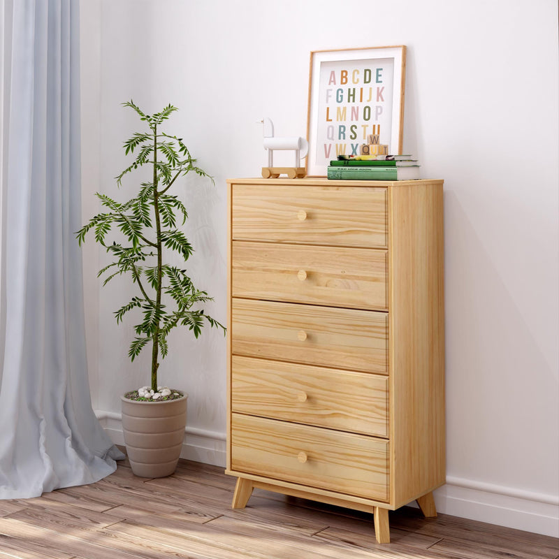 Light pine five-drawer dresser chest in bright modern bedroom with potted plant, framed alphabet print and hardwood floor