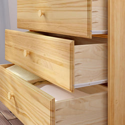 Wooden dresser with open drawers containing neatly folded clothes.