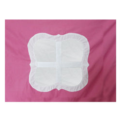 Decorative pink pillow with white windowpane design on a colorful fabric background.