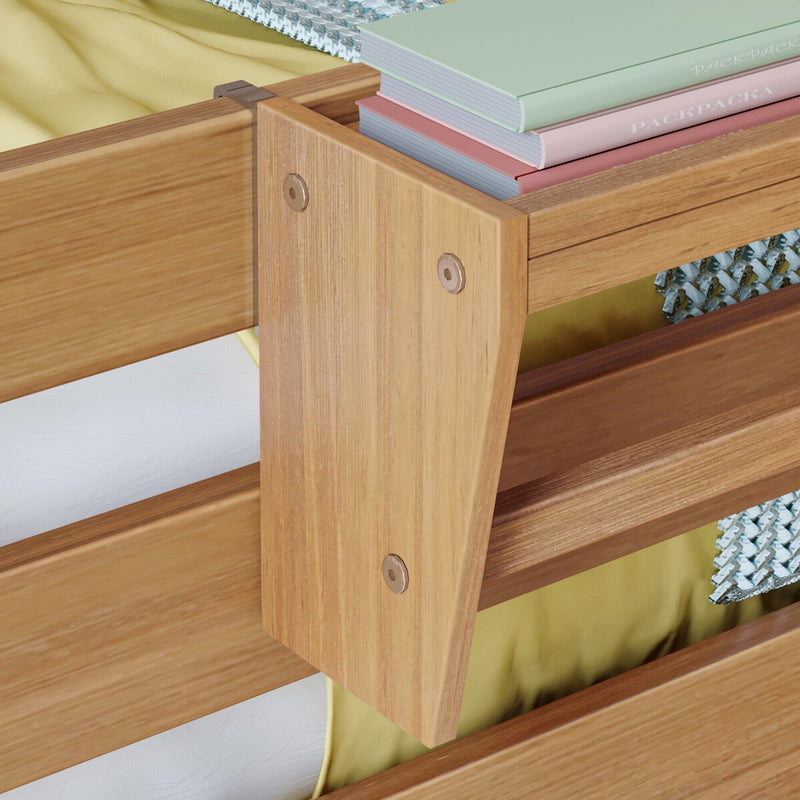 Close-up of light oak wooden bunk bed safety rail and slatted frame with yellow bedding and stacked pastel notebooks, sturdy kids loft bed design