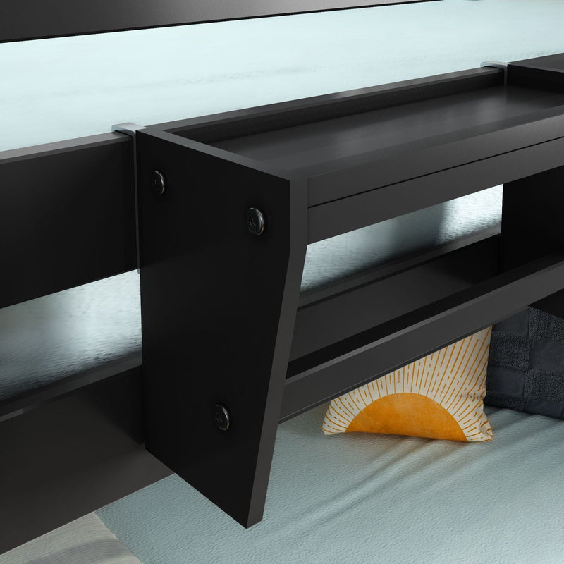 Modern black floating bedside shelf with built-in storage attached to bed frame over light blue bedding and yellow sunburst accent pillow — contemporary bedroom decor