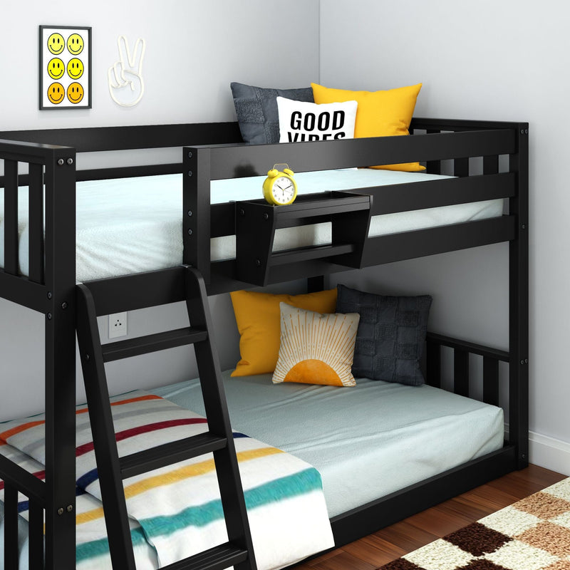 Black wooden twin-over-full bunk bed with ladder, light blue bedding, striped blanket, yellow and gray decorative pillows, yellow alarm clock and smiley wall art in modern kids' bedroom