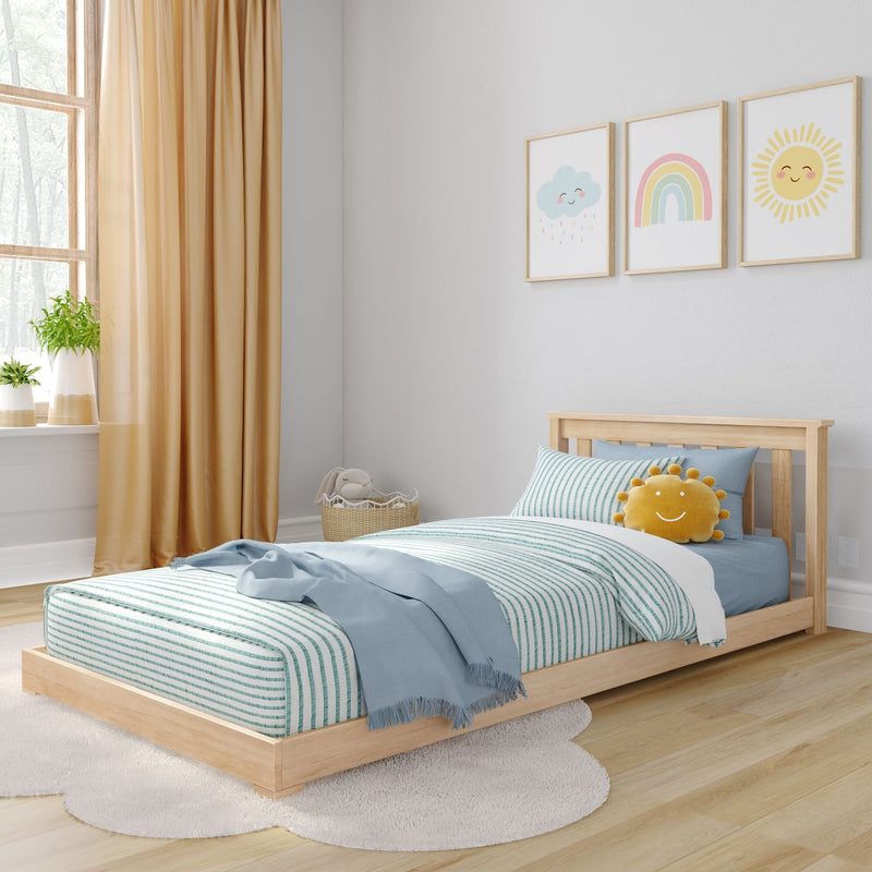 Sunny kids bedroom with natural wood platform twin bed, teal-and-white striped bedding, light blue throw, smiling sun plush, pastel rainbow and cloud wall art, mustard curtains and potted plants — modern children's room decor